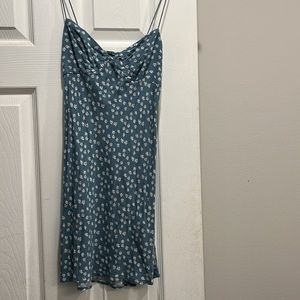 this is a blue dress with a white flower pattern or daisies